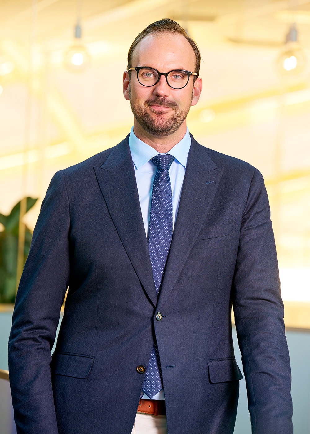 John Hansveden in suit, smiling.